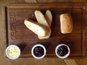 3 pieces of bread on a table with dips
